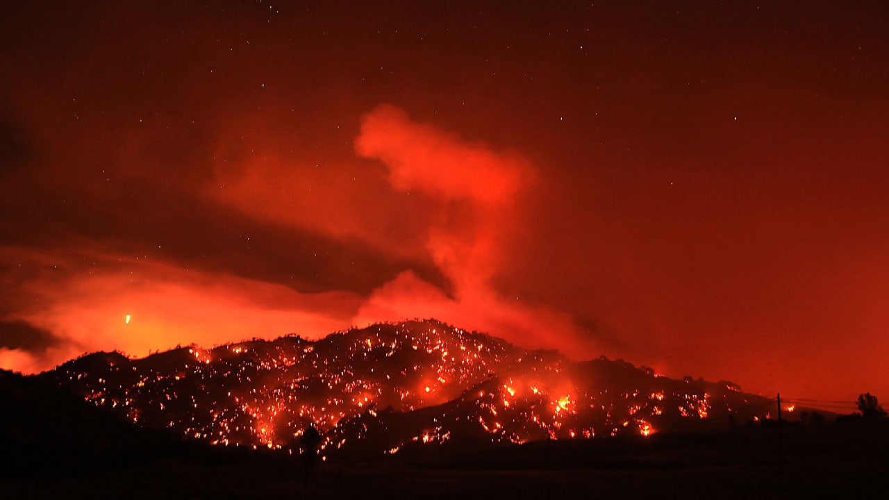 In this Tuesday, Aug. 2, 2016 photo, the Cold fire burns at night by the Solano and Napa County line near Lake Berryessa, California. (Kent Porter/The Press Democrat via AP)