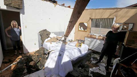 Mikela Kinnison, left, and her mother Ilona show the damage to the bedroom at Kinnison's home in San Antonio after tornadoes moved through the area late Sunday night. (Edward A. Ornelas/The San Antonio Express-News via AP)