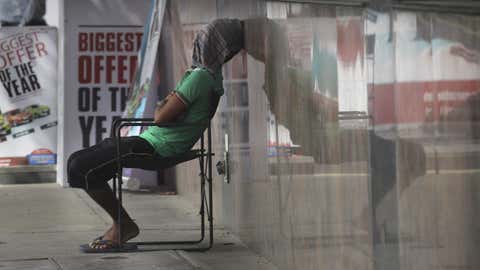 A worker rests under a shade putting a wet piece of cloth on his face on a hot summer afternoon in New Delhi, India, Monday, June 5, 2017. Most parts of northern India is reeling under intense heat wave conditions with the temperature crossing over 43 degrees Celsius (109.4 Fahrenheit). (AP Photo/Manish Swarup)