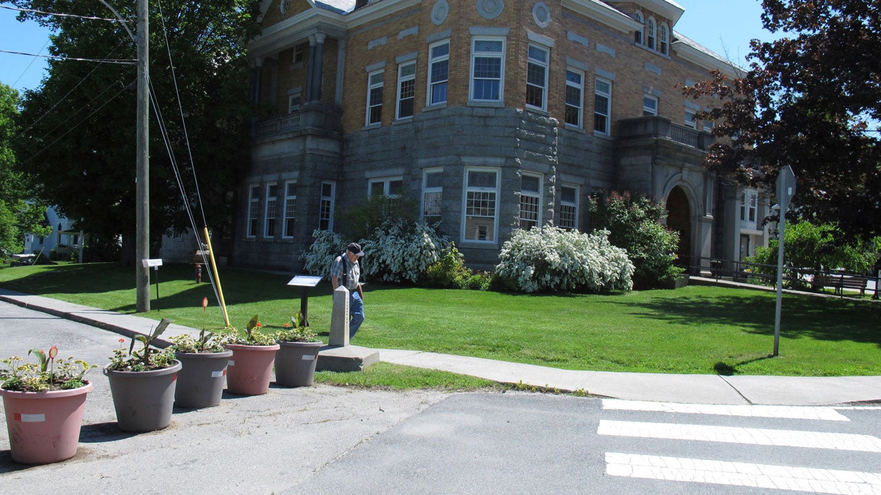 In the June 8, 2017, photo above, a border post and planters in Derby, Vermont, show the U.S.-Canadian border where it leads to a building located in the two countries. (AP Photo/Wilson Ring)