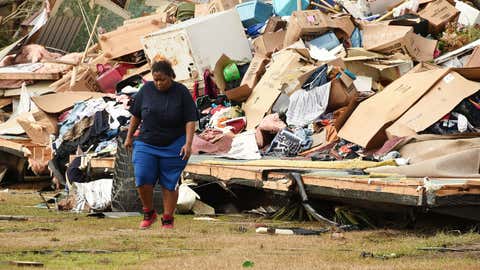 Shavone Hughes walks admist the devastation of her parents home near Aliceville, Alabama, on Wednesday, Feb. 3, 2016. (Joe Songer/AL.com via AP)