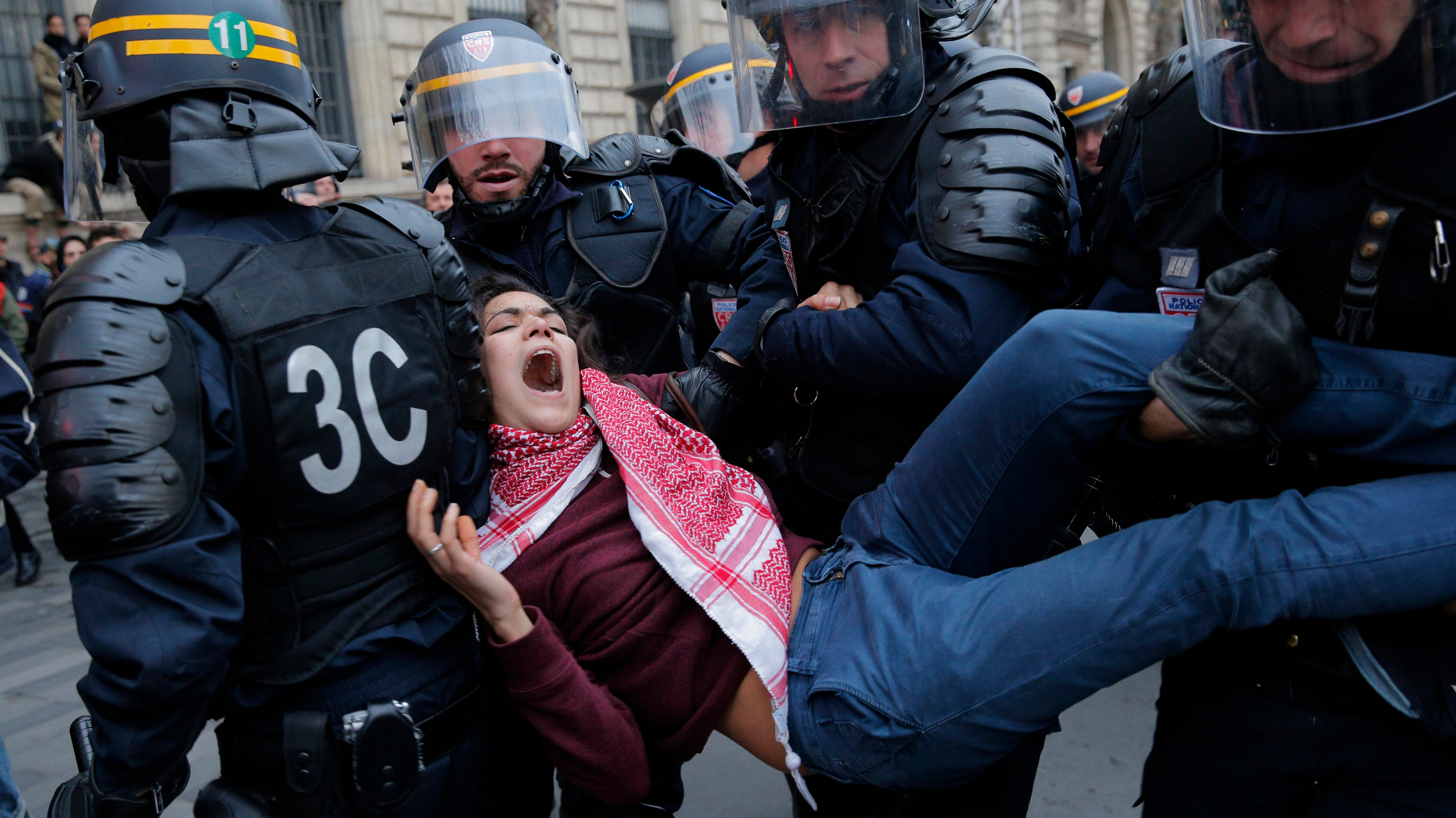 Policemen detain an activist during a protest ahead of the 2015 Paris Climate Conference, in Paris, France, on Nov. 29, 2015.