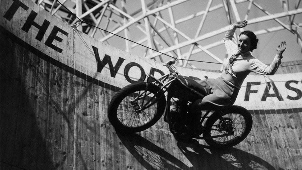 Marjorie Dare riding with around 'The Wall of Death' sideshow at the Kursaal amusement park in Southend, Essex, circa 1938. (Fox Photos/Hulton Archive/Getty Images)