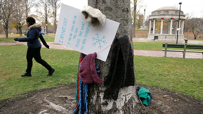 A Good Samaritan has been hanging scarves, coats, gloves, and mittens, for the needy on trees in the Boston Common. (AP Photo/Steven Senne)