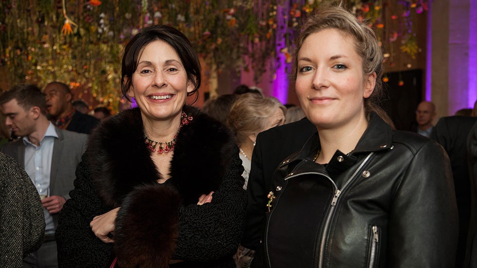 Exhibit curator Nicola Schulman, left, and floral artist Rebecca Louise Law (right), stand beneath Law's latest piece of work on display at London's Garden Museum. (Image: Jayne Lloyd/Garden World Images)