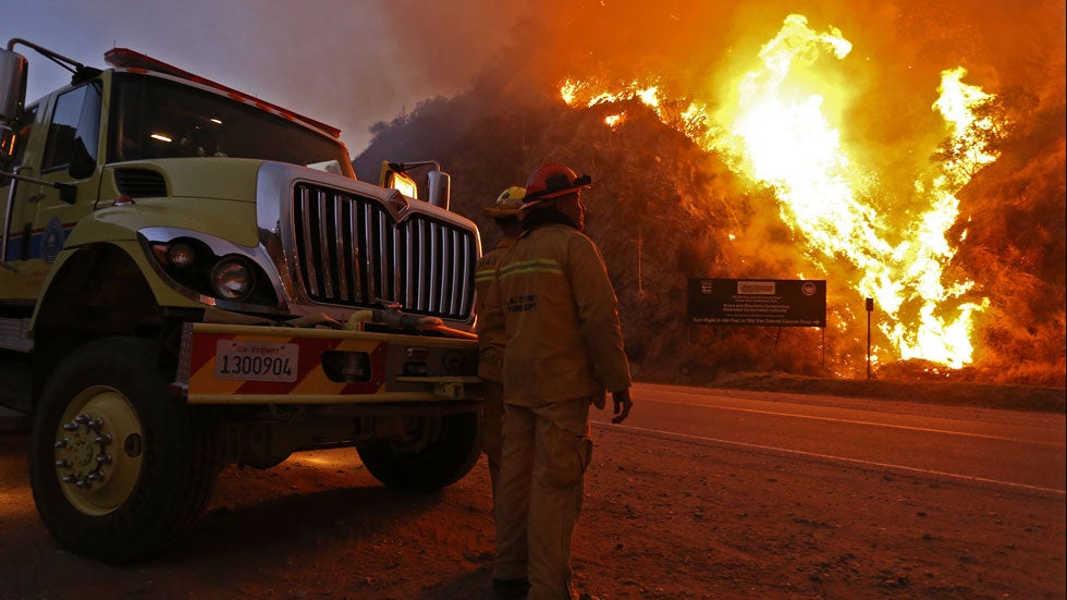 Firefighters monitor the Colby fire burning for a second day on a hillside on Highway 39 in Azusa, California. (Jonathan Alcorn/Getty Images)