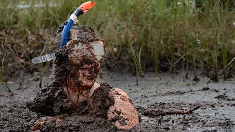 Participant Gemma Woods takes a dip in the Bog Jacuzzi after competing in the Irish Bog Snorkelling championship on July 27, 2014 in Dungannon, Northern Ireland. (Charles McQuillan/Getty Images)