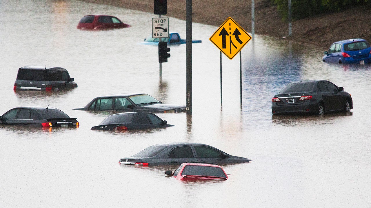 Cars are underwater at 43rd Ave. and I-10 in the westbound lanes in Phoenix, Monday, Sept. 8, 2014, after record-setting rainfall caused massive flooding throughout the Valley. (AP Photo/The Arizona Republic, Tom Tingle)