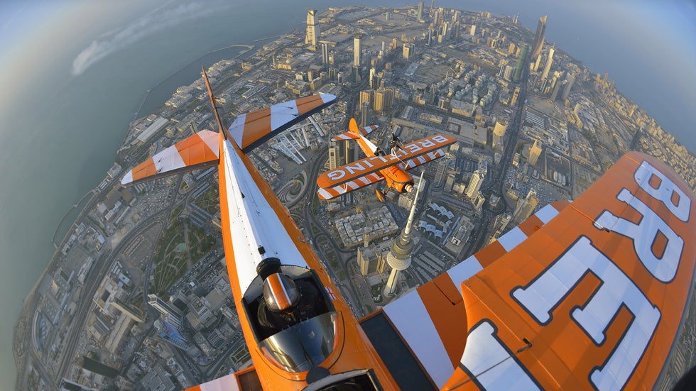 Breitling Wingwalker Freya Paterson flies above Kuwait City's iconic Water Towers with pilots David Barrell and Martyn Carrington on Thursday, March  6, 2014.  The team loop and roll up to 160 mph enduring G-forces of 4-5g. (Katsuhiko Tokunaga/Breitling via AP Images)