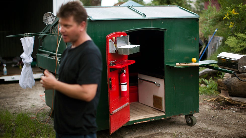 Gregory Kloehn speaks to a reporter outside his 'dumpster home' in the Red Hook neighborhood of New York's Brooklyn borough. (AP Photo/John Minchillo)