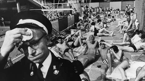 A man on duty at the Holborn Oasis swimming pool in London, suffering in the July heat. (Keystone/Getty Images)