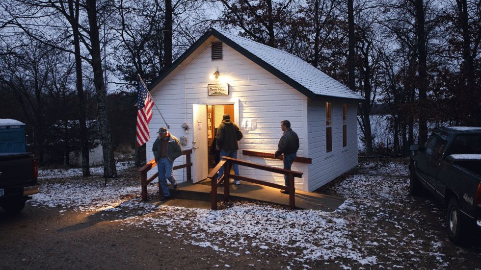 A light wet snow covers the roof and ground around the Jenkins Town Hall as early voters casts their ballots Tuesday, Nov. 6, 2012 in Jenkins, Minn. Jenkins is located in Crow Wing County in northern Minnesota. (AP Photo/Tom Olmscheid)