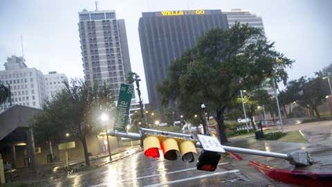 A damaged stop light blocks a street as Hurricane Harvey makes landfall in Corpus Christi, Texas, on Friday, Aug. 25, 2017. Hurricane Harvey smashed into Texas late Friday, lashing a wide swath of the Gulf Coast with strong winds and torrential rain from the fiercest hurricane to hit the U.S. in more than a decade. (Nick Wagner/Austin American-Statesman via AP)