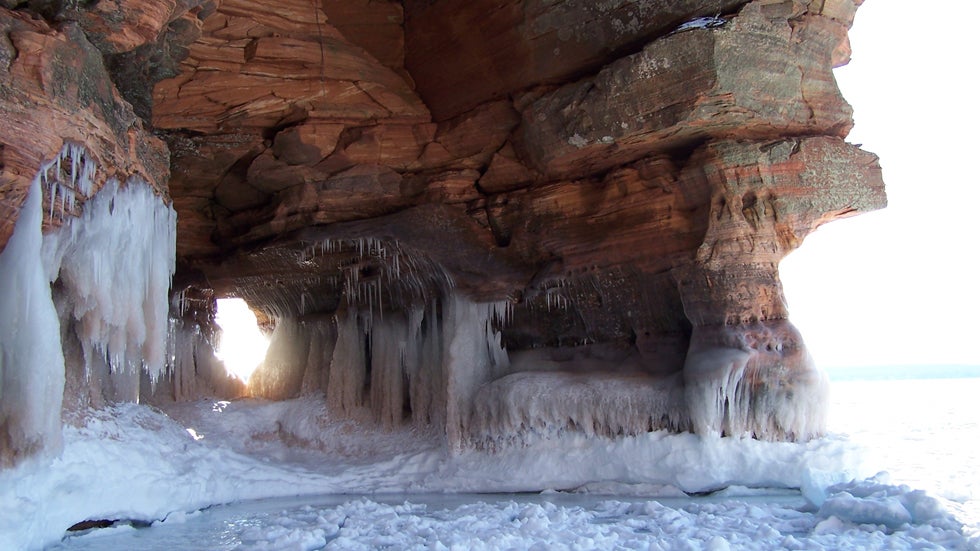 Walls of ice encrust the lower cliffs where wave spray has frozen on the rock, Apostle Islands National Lakeshore. (National Park Service)