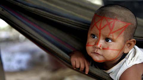 An indigenous girl belonging to the Nukak-Maku ethnic group, the last nomadic people of Colombia, lays in a hammock on April 7, 2008, in a provisional settlement in Barrancon Bajo near San Jose del Guaviare. (RODRIGO ARANGUA/AFP/Getty Images)