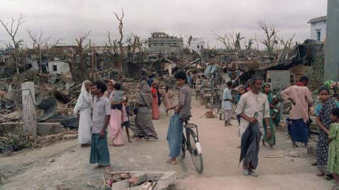 Bangladeshi men, women and children walk in the ruins of their city on April 30, 1989, in Saturia, as the houses were reduced to scraps during a severe tornado on April 26. Image credit: David L. Nelson/AFP/Getty Images