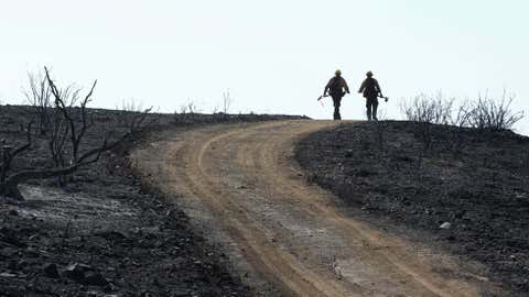 U.S. Forest Service firefighters walk a scorched ridge at the Springs fire on May 4, 2013 near Camarillo, California. (David McNew/Getty Images)