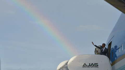 A rainbow appears in the sky as President Barack Obama waves from the Air Force One in Kingston,Jamaica,on April 9,2015.