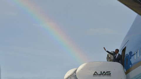 A rainbow appears in the sky as President Barack Obama waves from the Air Force One in Kingston, Jamaica, on April 9, 2015. 