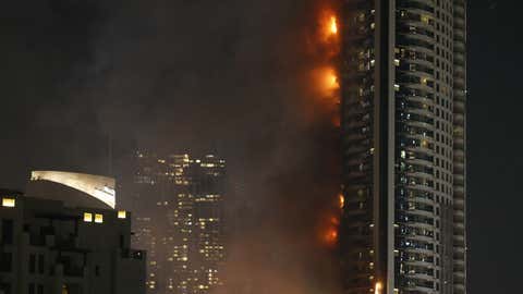 The photo above shows the Address Downtown hotel burning after a huge fire ripped through the luxury hotel near the world's tallest tower in Dubai on Dec. 31, 2015.