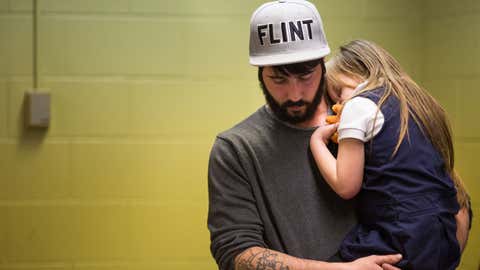 Matt Hopper holds and comforts Nyla Hopper, age 5 of Flint, after she has her blood drawn to be tested for lead on January 26, 2016 at Eisenhower Elementary School in Flint, Michigan. (Brett Carlsen/Getty Images)