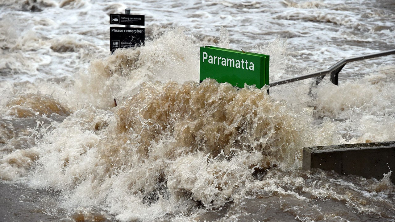 A ferry terminal is submerged by the overflowing Parramatta river in Sydney, Australia, on June 5, 2016. The east coast of Australia, including Sydney, was battered by a freak storm on June 5 with trees uprooted and thousands left without power.