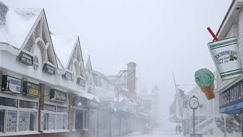 People walk on the boardwalk on January 7, 2017 in Ocean City, Maryland. It's estimated that Winter Storm Helena dumped more than eight inches of snow in the lower Eastern Shore of Maryland as Ocean City was under a Winter Storm Warning. (Photo by Patrick Smith/Getty Images)