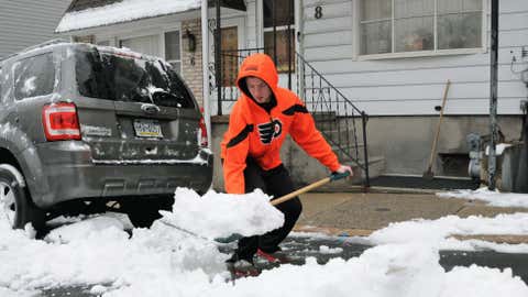 Eric Heck,shows proper form as he bends at the knees shoveling snow on S. 19th Street,Wednesday,Jan. 16,2013 in Pottsville,Pa.