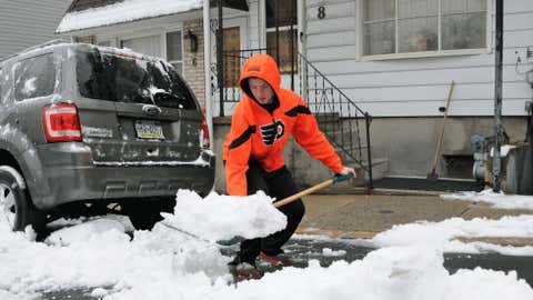 Eric Heck, shows proper form as he bends at the knees shoveling snow on S. 19th Street, Wednesday, Jan. 16, 2013 in Pottsville, Pa.