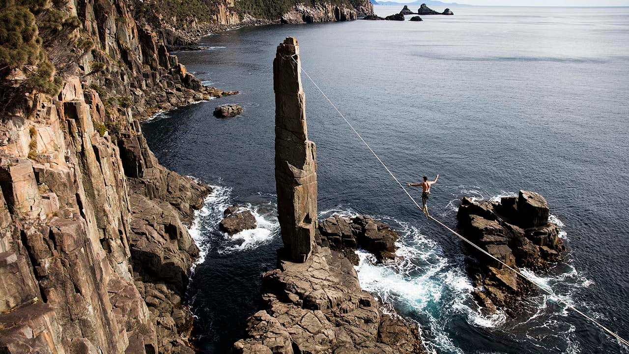 Ryan Robinson walks across a highline in Tasmania, Australia. (Krystle Wright/Caters News)