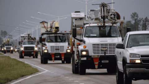 A steady armada of utility service trucks drive through Waveland, Miss., to assist residents left without power from Hurricane Isaac, Thursday, Aug. 30, 2012. Signs of life returned to the Mississippi Gulf Coast on Thursday as curfews were lifted and some businesses and roads reopened. 