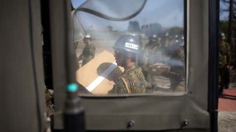 Japan Self-Defense Forces prepare relief supplies delivered by a U.S Marine Corp Osprey following an earthquake, on April 19, 2016 in Minamiaso near Kumamoto, Japan. (Carl Court/Getty Images)