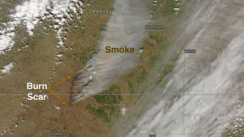 True color high-resolution visible satellite image of the Kansas/Oklahoma wildfire on March 23, 2016. The smoke plume can be seen in light brown. The wildfire's burn scar is the dark brown land near the Kansas and Oklahoma border near the center of the image (NASA Worldview).