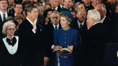 Due to the cold, President Ronald Reagan takes the oath of office for his second term as President in the Capitol Rotunda on Jan. 21, 1985.
