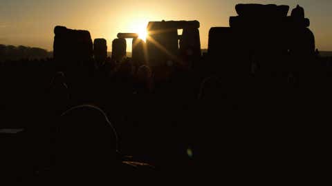 The sun passes through the stones after rising at the ancient stone circle of Stonehenge, in southern England, as access to the site is given to druids, New Age followers and members of the public on the annual Winter Solstice, Friday, Dec. 21, 2012.