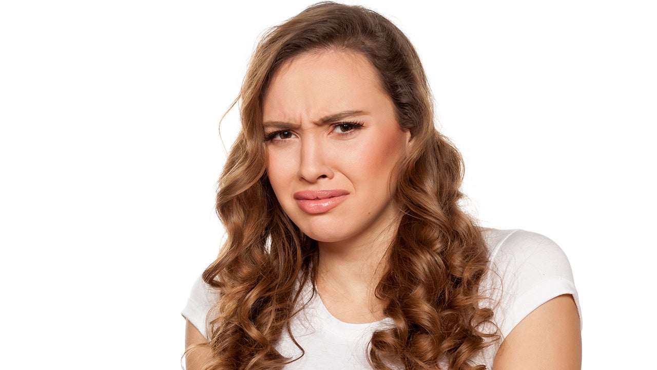pretty disgusted girl on a white background