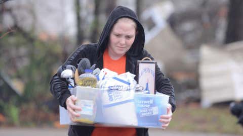 A woman carries belongings down a street after a tornado left heavy damage in Hattiesburg, Sunday, Feb. 10, 2013. (Photo: Matt Bush)