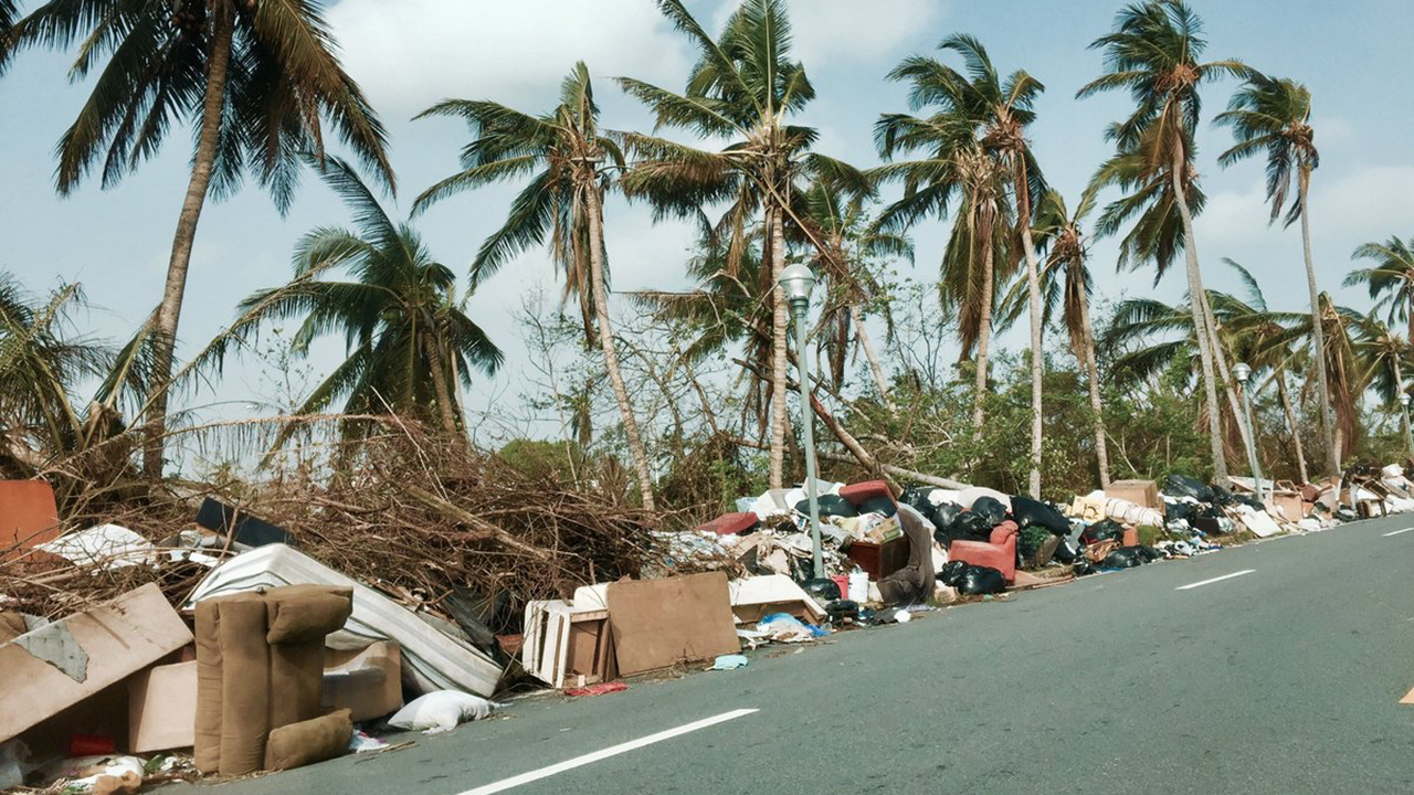 Damaged and abandoned belongings pile up along a road in Toa Baja, Puerto Rico, on Thursday, October 19, 2017. (Twitter/@camillecardona4)