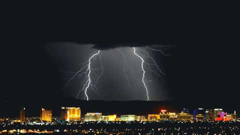 Lightning flashes east of the Las Vegas Strip during a thunderstorm early on September 13, 2011 in Las Vegas, Nevada. (Photo credit:  Ethan Miller/Getty Images)