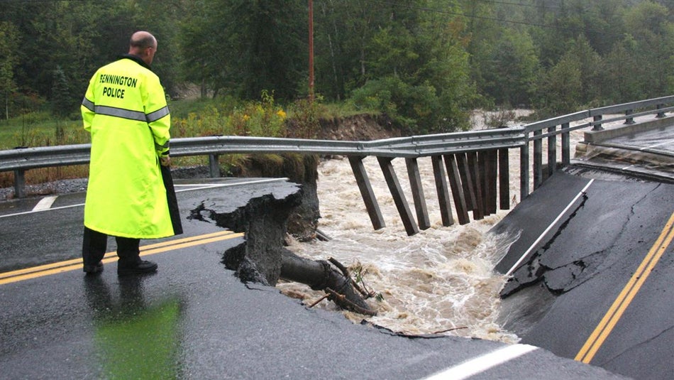 Bennington Police Chief Paul Doucette looks at a collapsed bridge on Route 9 in Woodford, Vermont, on Aug. 28, 2011.