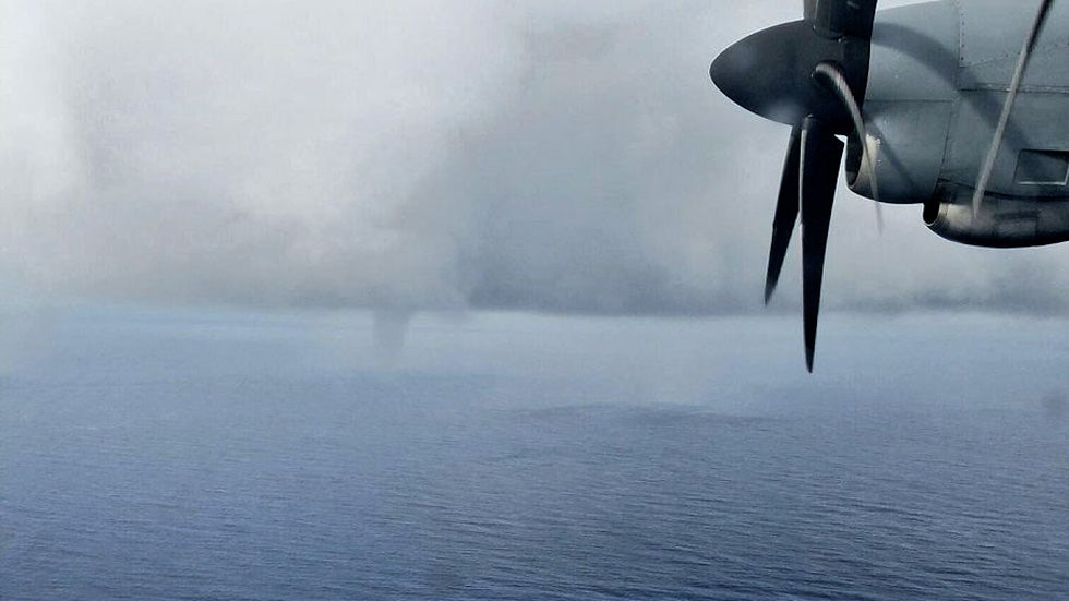 A hurricane hunter crew member snapped a shot of a waterspout ahead of Invest 93L which became Tropical Storm Colin. (Loadmaster MSgt Ed Scherzer/USAF Reserve Hurricane Hunters)