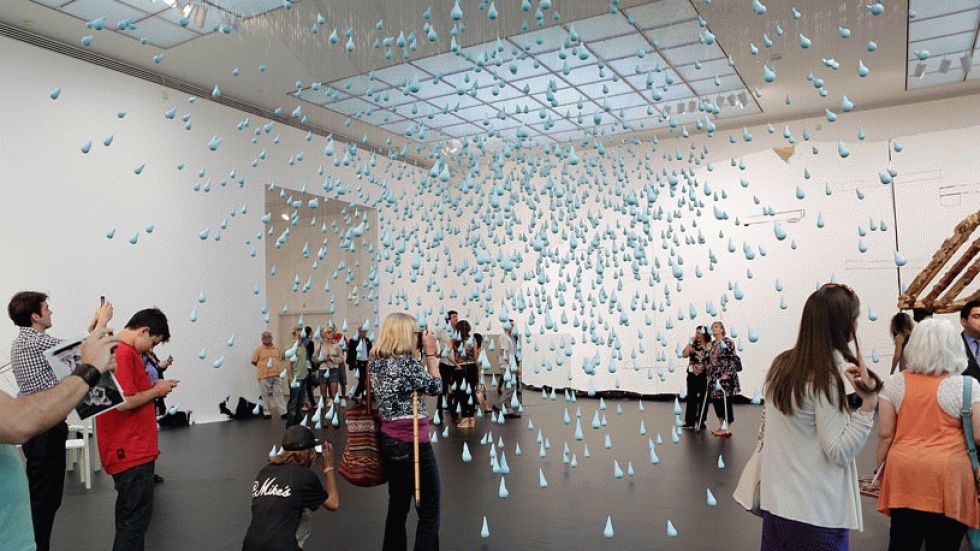 Members of the public view Urs Fischer's 'Horses Dream of Horses,' an installation of 1,500 hanging plaster and resin raindrops, part of his retrospective at Los Angeles' MOCA. (Photo: Mike Windle/Getty Images for MOCA)
