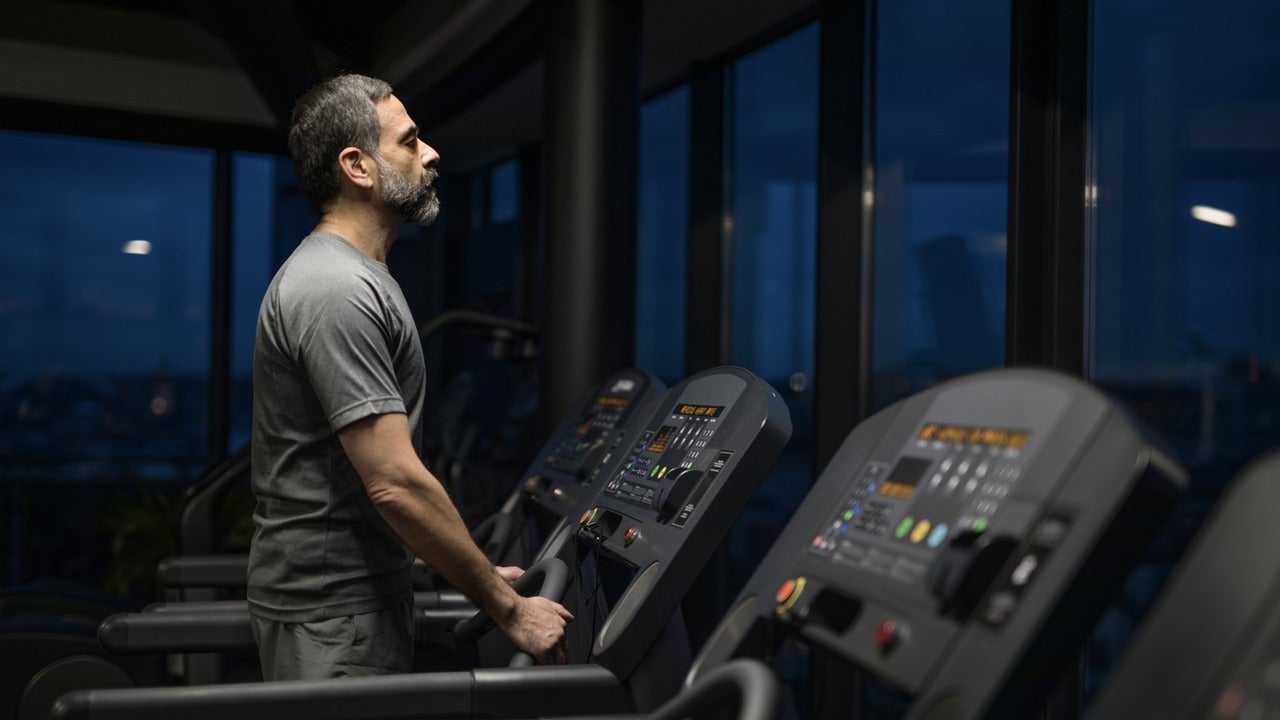 Man at exercise machine in the dark