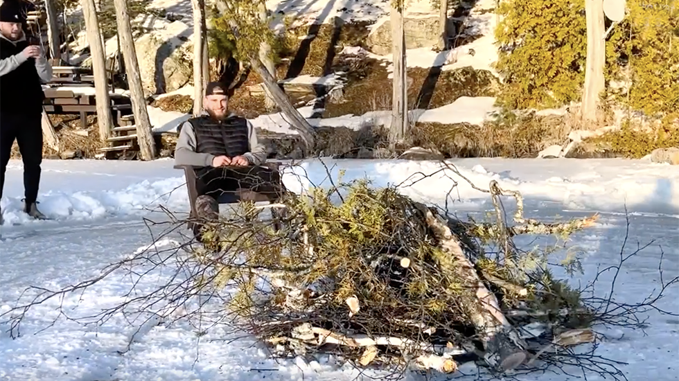 Two Friends Sit On Spinning Ice Disk On Canada Lake