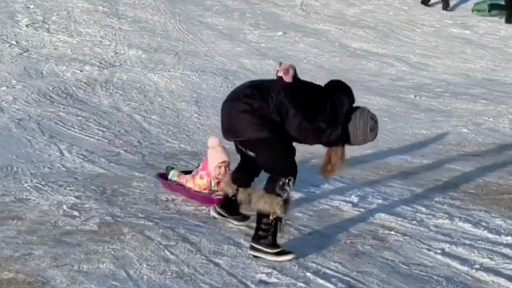 Mom Struggles to Pull Sled Up Icy Hill