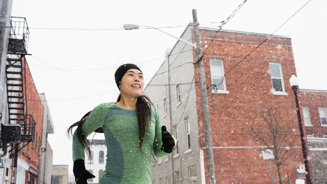 Woman running in city during cold weather