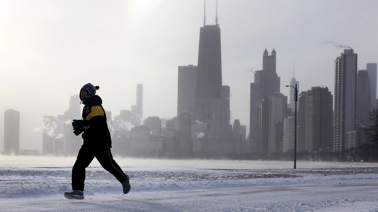 Runner in shadow against city skyline