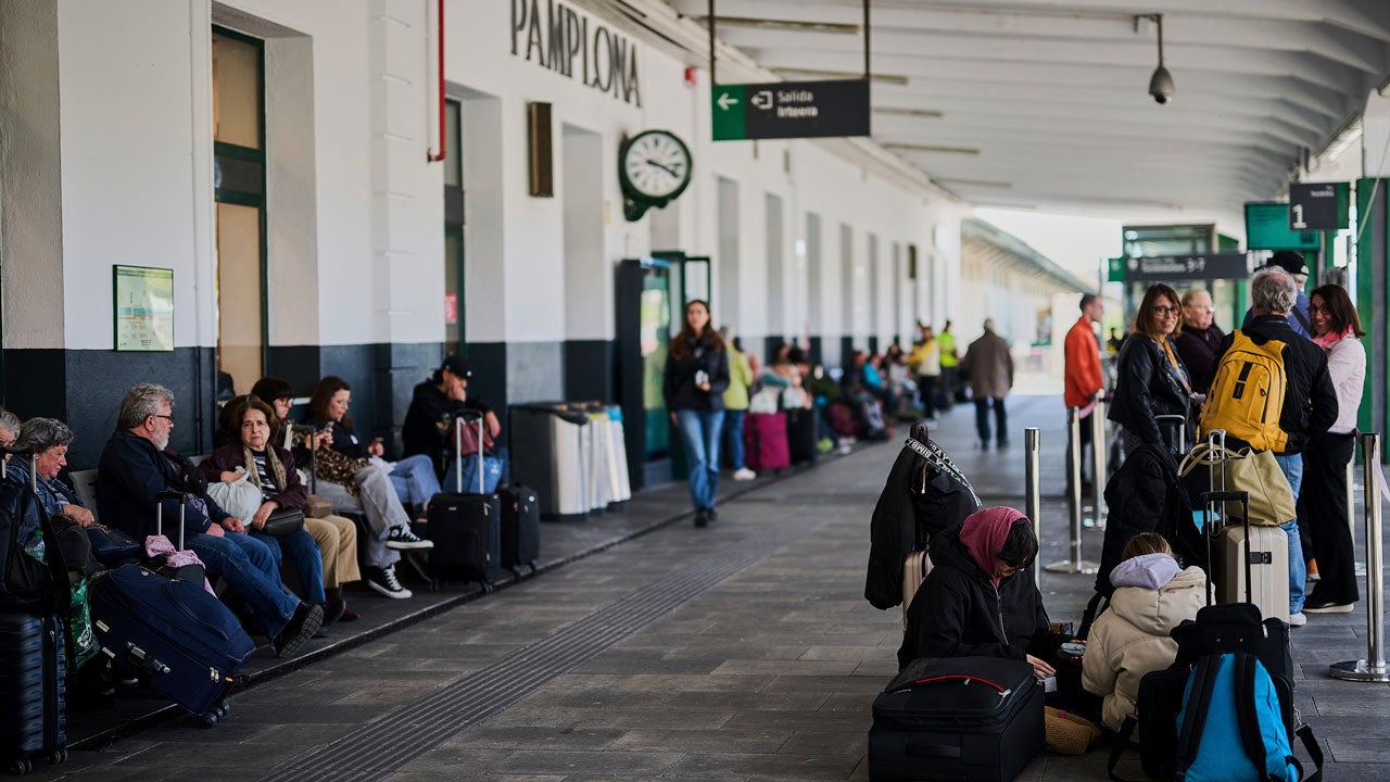 People sit around and wait for trains during a power outage