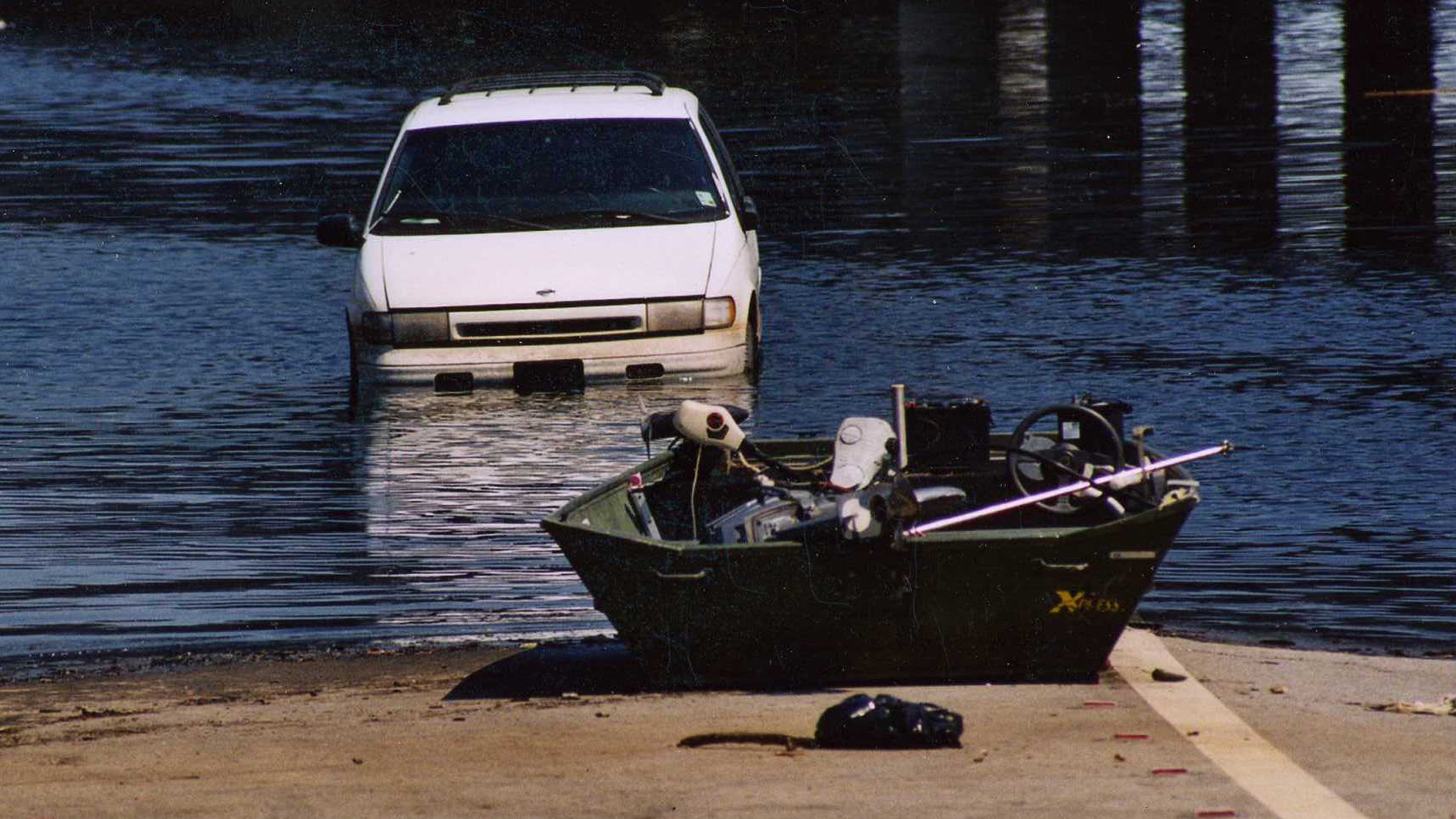 Floodwaters from Hurricane Katrina submerged cars beneath murky waves and pushed boats into streets.