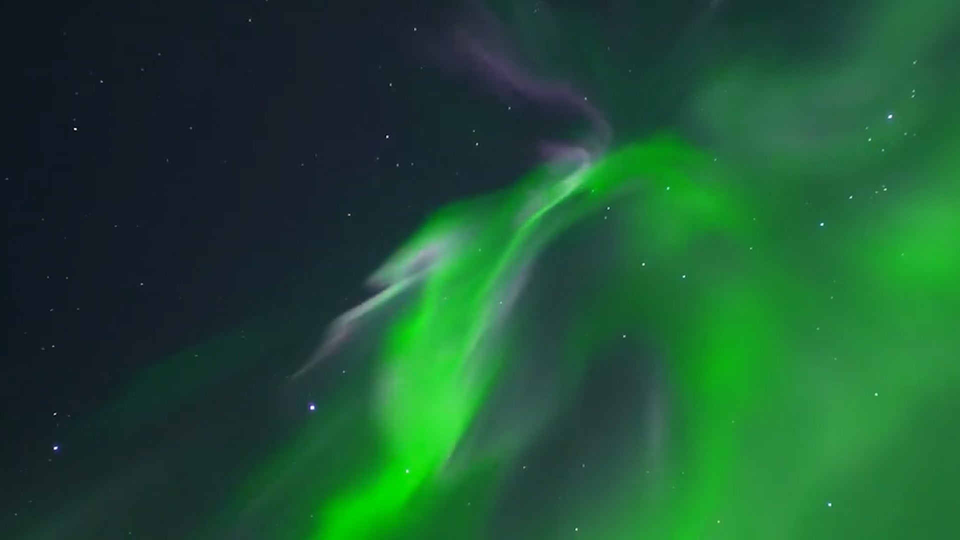 Watch The Northern Lights Swirl Over A Small Alaska Town